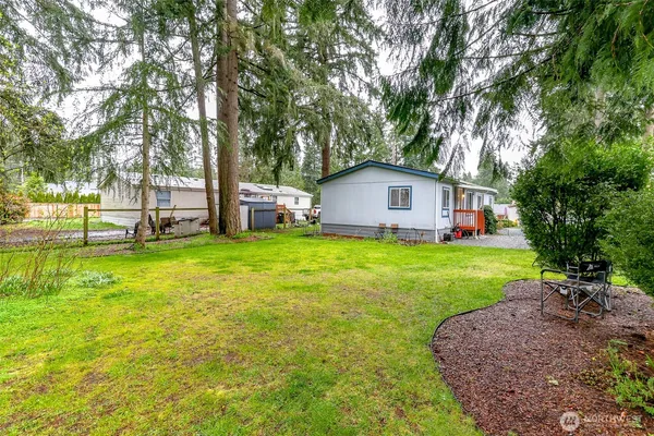 a view of a house with backyard and sitting area