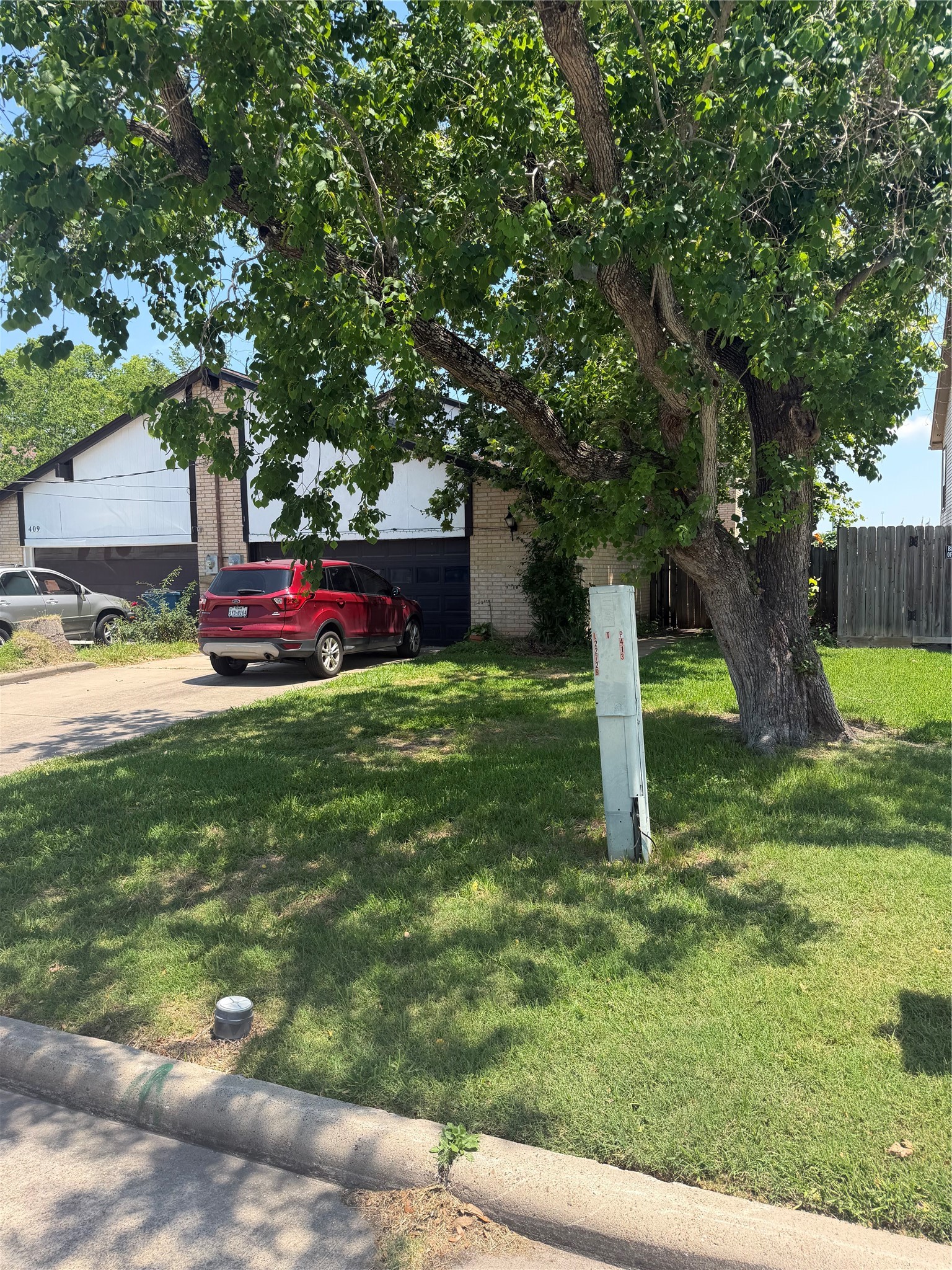 411 South Austin Street Webster, TX 77598 - Photo 2 of 13 a view of a house with a yard
