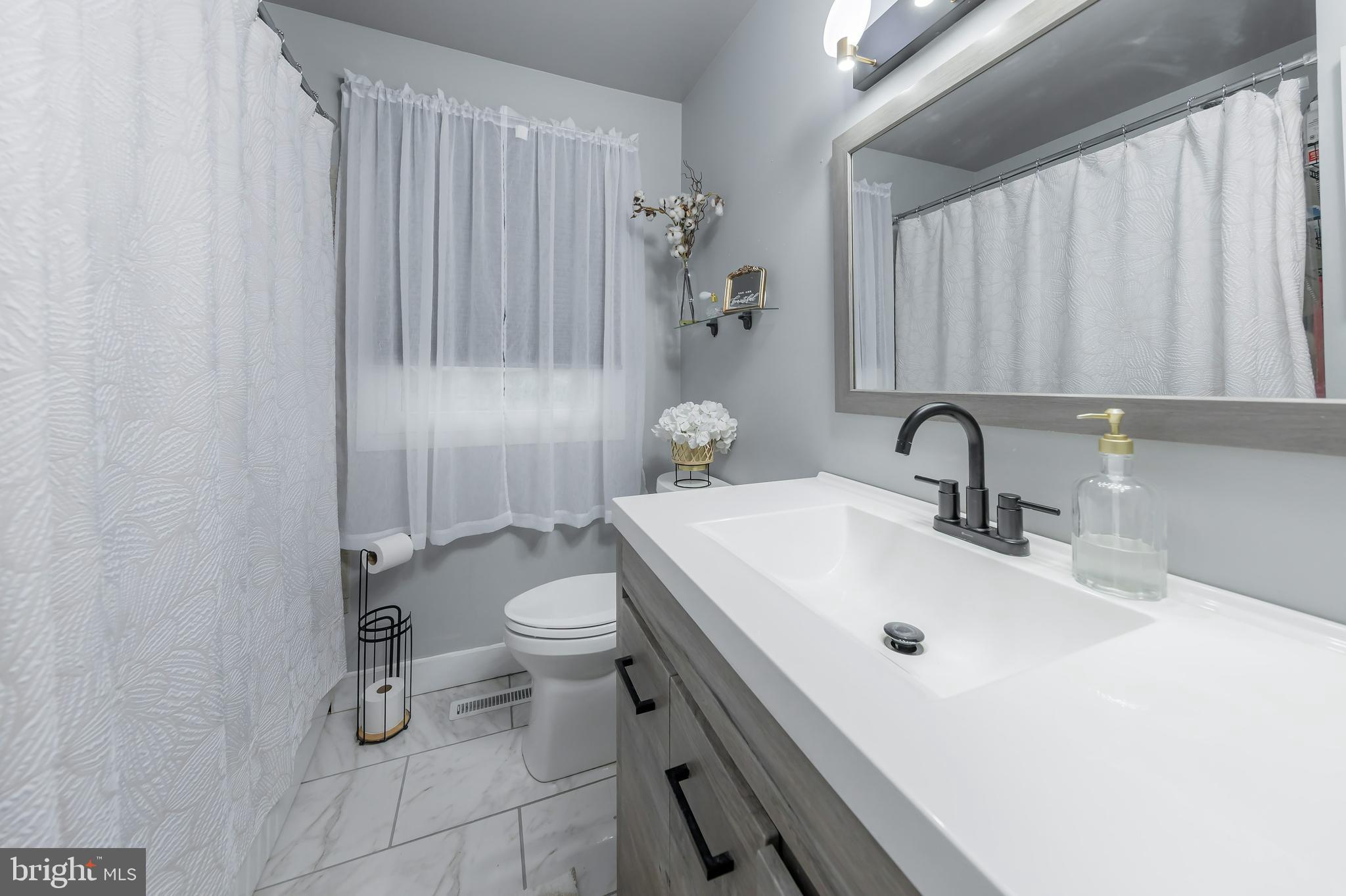 414 Westminster Road Wenonah, NJ 08090 - Photo 9 of 21 a bathroom with a sink a toilet and shower