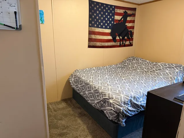 a bedroom with a bed and wall painting