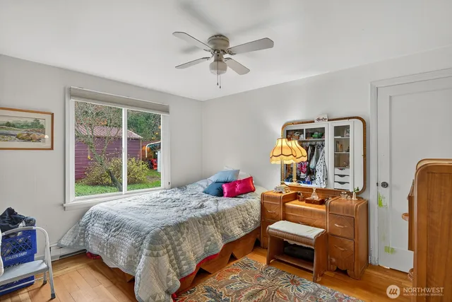 a bedroom with bed and a window