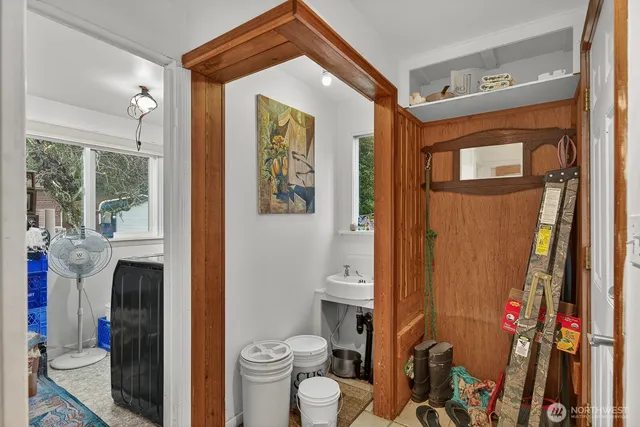 a bathroom with a toilet sink and shower curtain