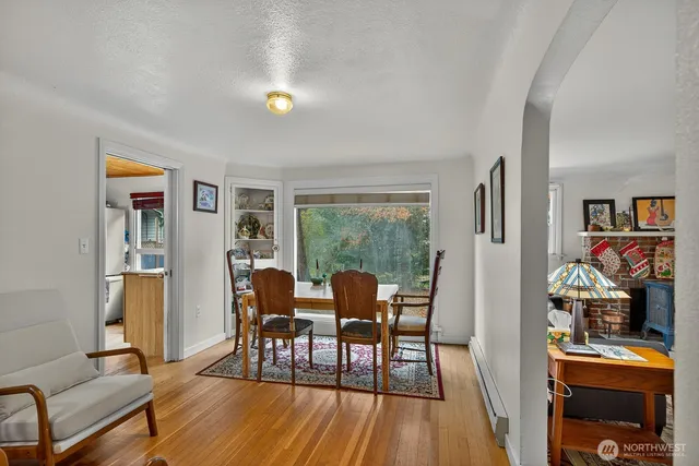 a dining room with furniture a window and wooden floor