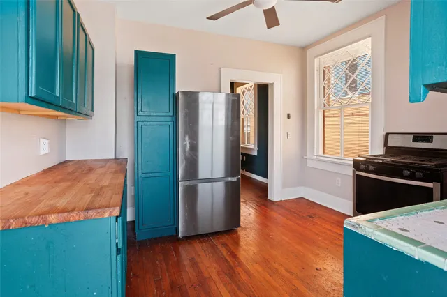 a kitchen with stainless steel appliances granite countertop a refrigerator and a stove