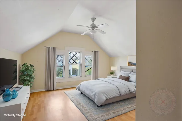 a bedroom with a large bed and a large window