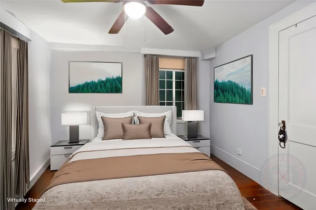 a bedroom with a large bed and a flat tv screen