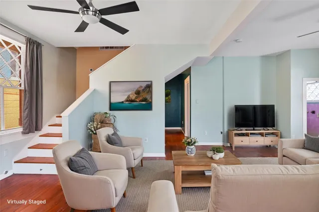 a living room with furniture and a flat screen tv