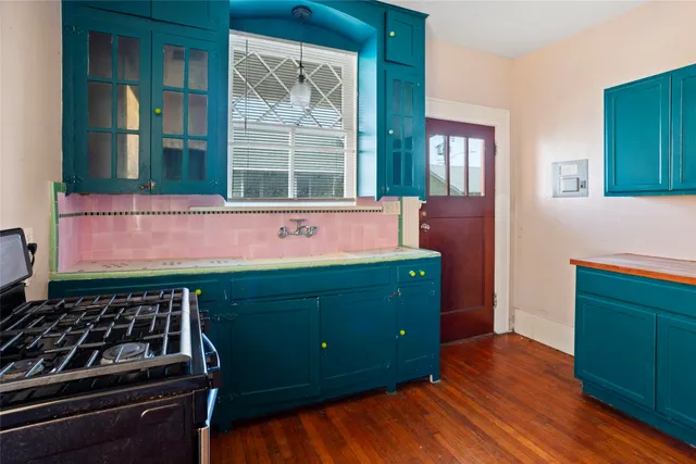 a kitchen with wooden floors and a stove