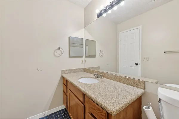 a bathroom with a sink vanity and a mirror