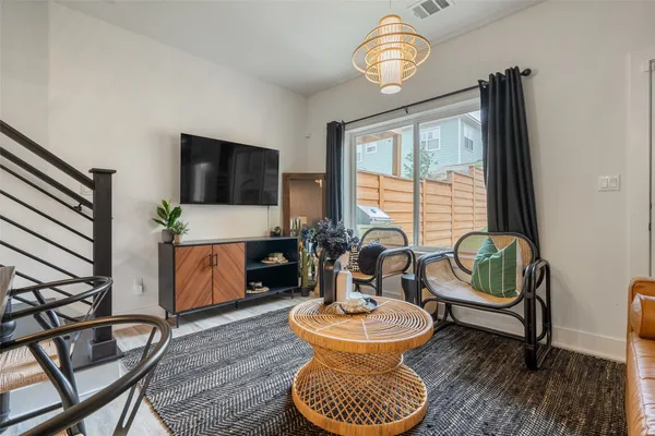 a living room with furniture a window and a flat screen tv
