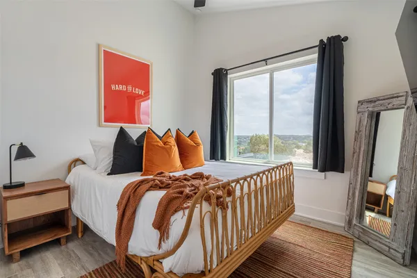 a bedroom with bed and a large window
