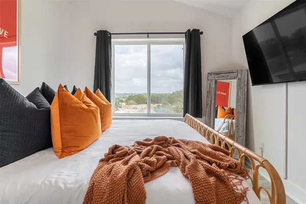 a bed sitting in a bedroom next to a window