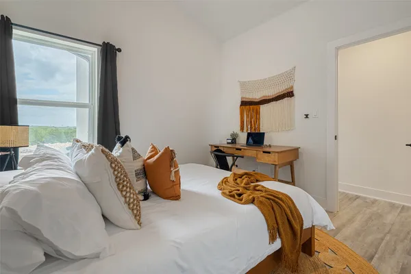 a bedroom with a bed and window