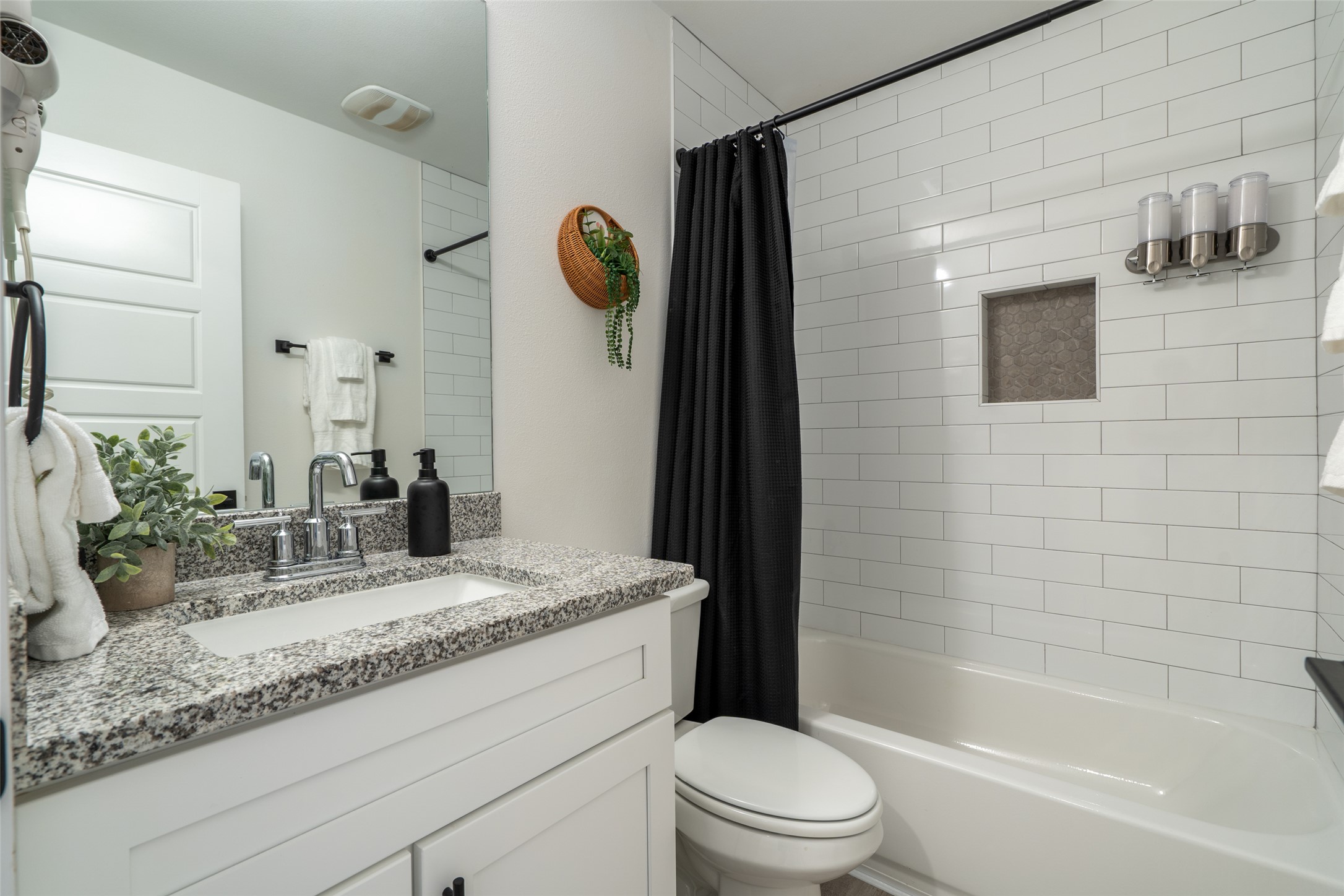 21202 Boggy Ford Road, Unit 6 Lago Vista, TX 78645 - Photo 21 of 36 a bathroom with a granite countertop sink mirror vanity and toilet