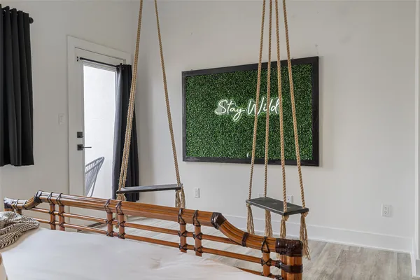 a living room with balcony a bed and a large window