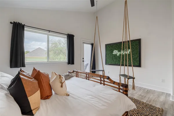 a bedroom with a bed and large window