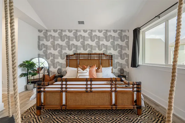 a bedroom with bed and a flat tv screen