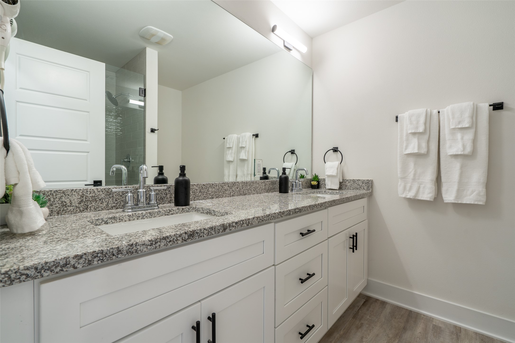 21202 Boggy Ford Road, Unit 6 Lago Vista, TX 78645 - Photo 29 of 36 a bathroom with a granite countertop sink and a mirror