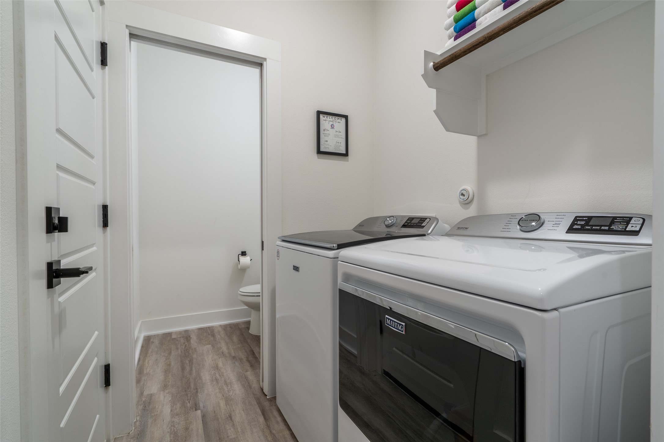 21202 Boggy Ford Road, Unit 6 Lago Vista, TX 78645 - Photo 3 of 36 a utility room with washer and dryer