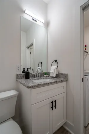 a bathroom with a toilet sink and mirror