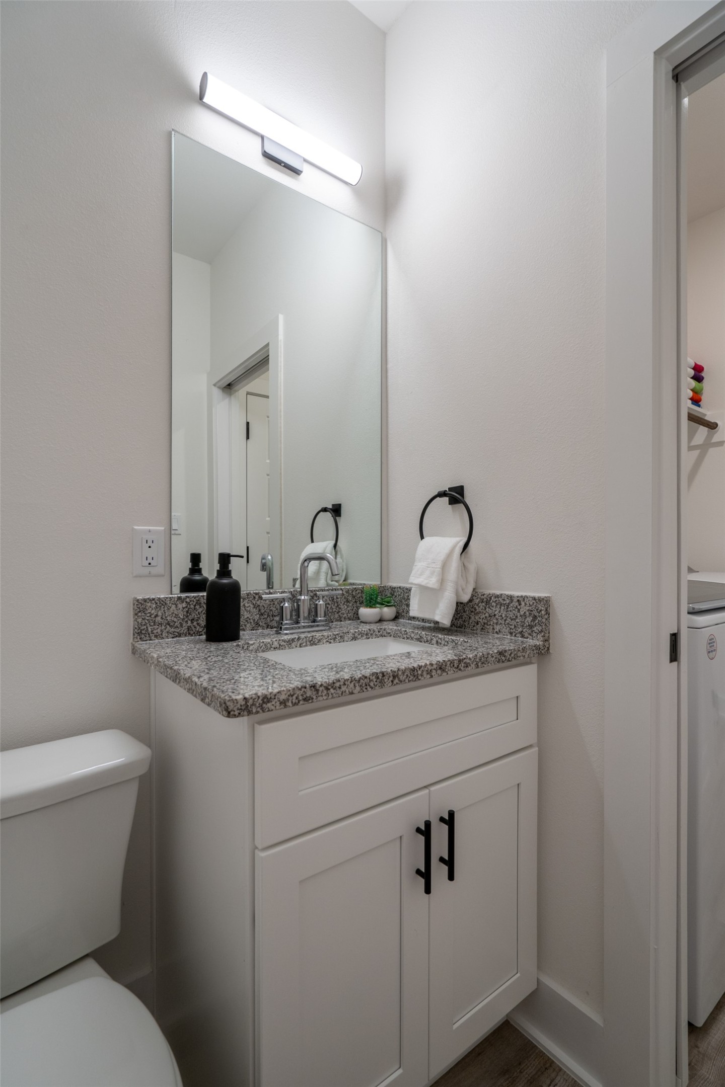 21202 Boggy Ford Road, Unit 6 Lago Vista, TX 78645 - Photo 7 of 36 a bathroom with a toilet sink and mirror