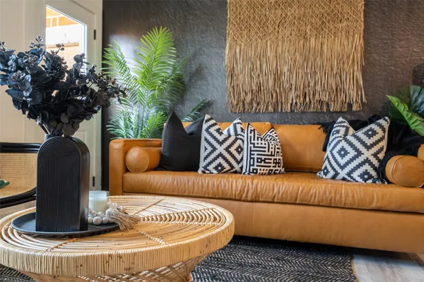 a living room with furniture and a potted plant