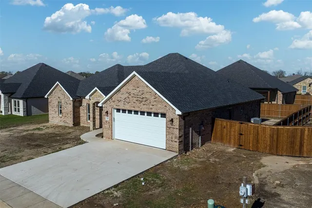 a view of a house with a yard and garage
