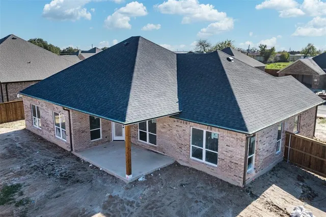 a view of a house with roof deck and furniture