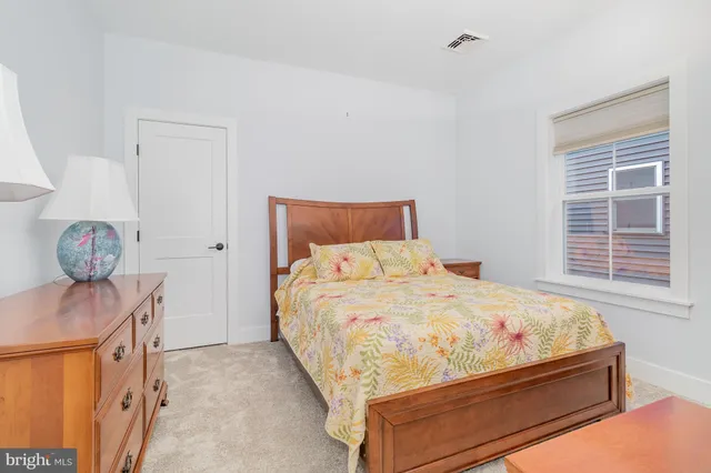 a bed room with a bed and a dresser