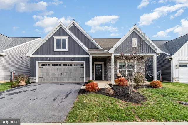 a front view of a house with garden and porch