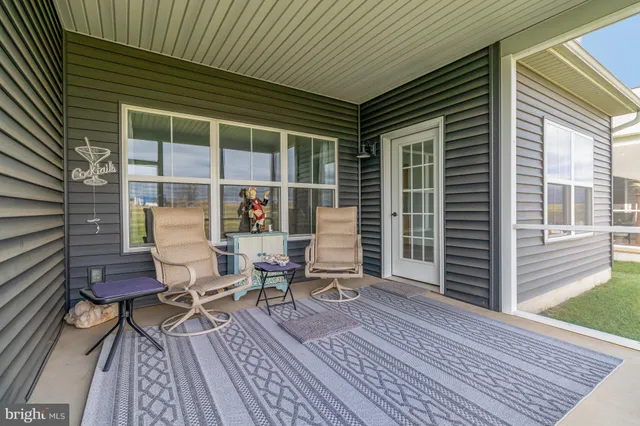 a view of a room with wooden floor and windows