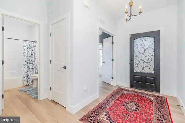 a view of an entryway with wooden floor
