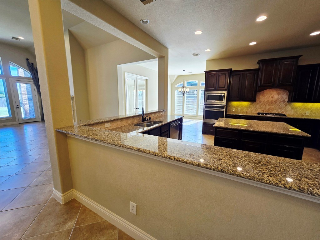 4311 Piper Shadow Lane Katy, TX 77494 - Photo 13 of 29 a living room with stainless steel appliances kitchen island granite countertop furniture and a view of living room