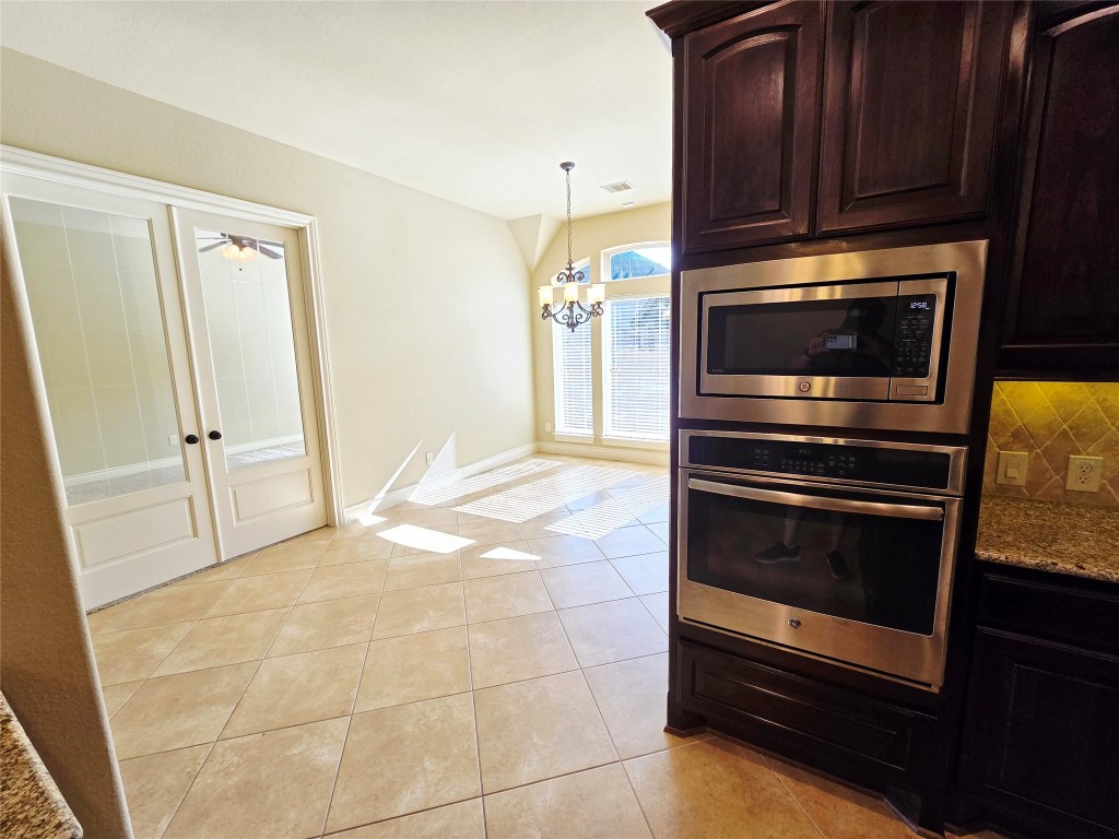 4311 Piper Shadow Lane Katy, TX 77494 - Photo 14 of 29 a kitchen with granite countertop a refrigerator and a stove top oven