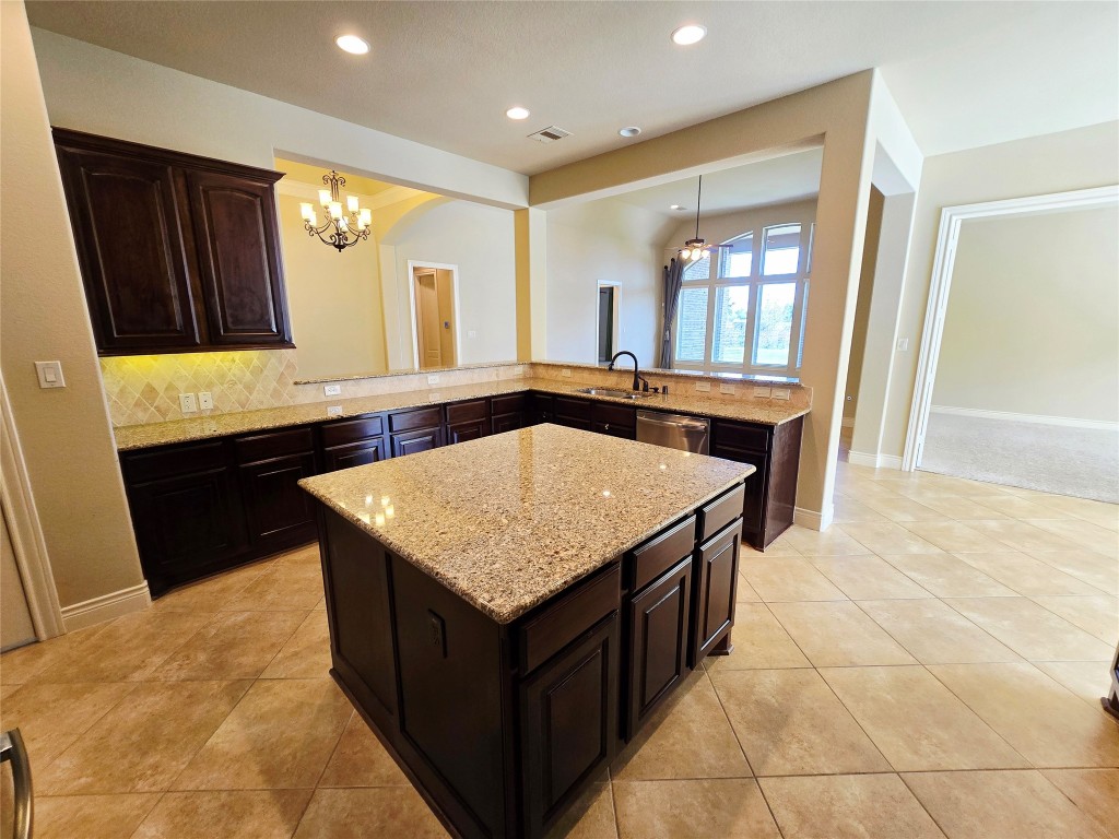 4311 Piper Shadow Lane Katy, TX 77494 - Photo 18 of 29 a kitchen with a sink a counter top space and cabinets