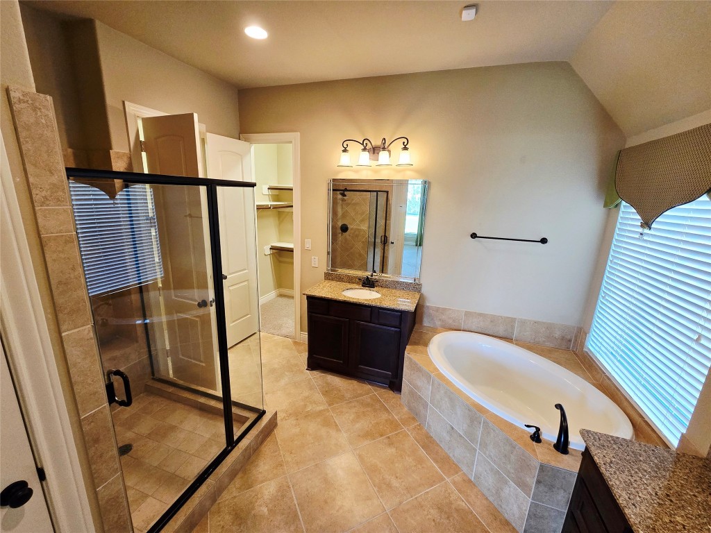 4311 Piper Shadow Lane Katy, TX 77494 - Photo 25 of 29 a bathroom with a tub sink and mirror
