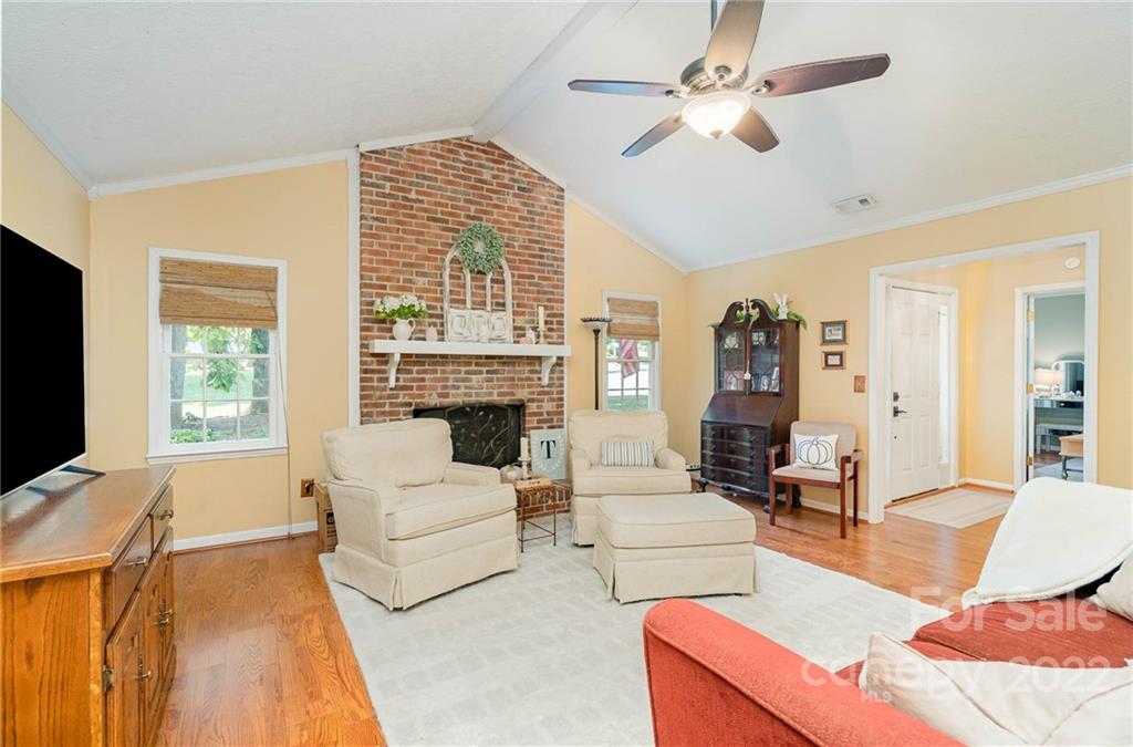 6901 Porterfield Road Charlotte, NC 28226 - Photo 11 of 30 a living room with furniture a fireplace and a flat screen tv