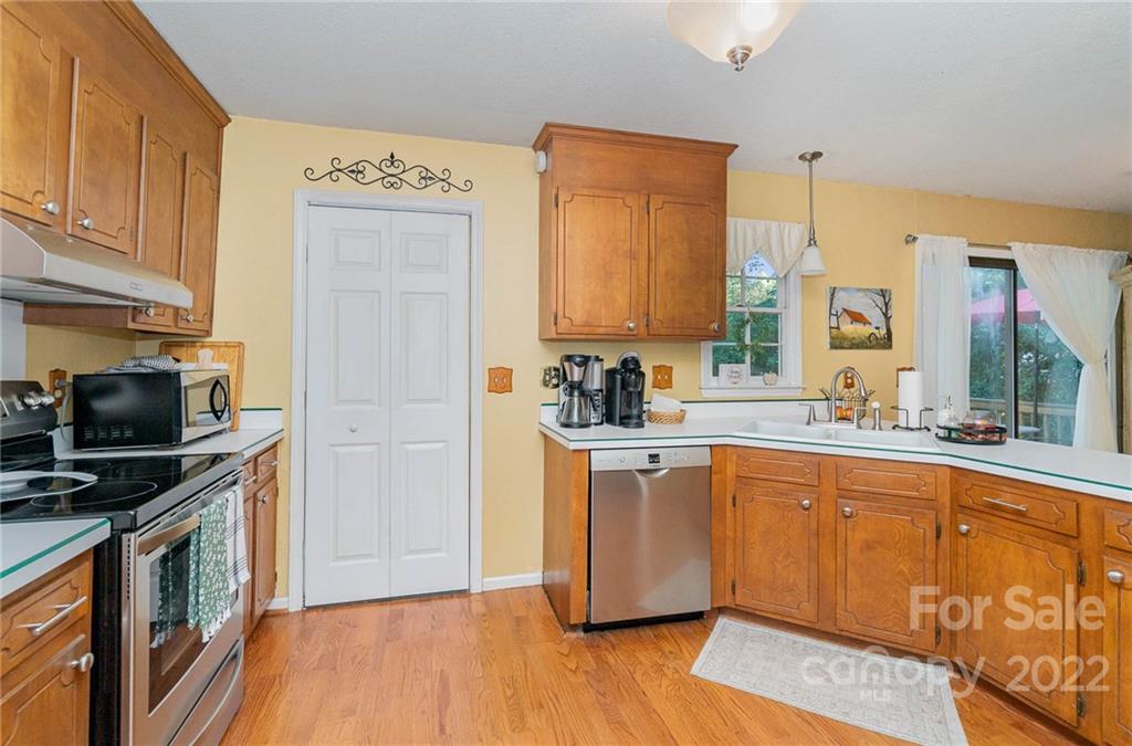6901 Porterfield Road Charlotte, NC 28226 - Photo 14 of 30 a kitchen with stainless steel appliances granite countertop a stove a sink and a refrigerator