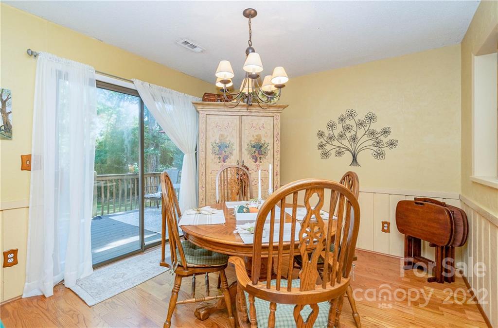 6901 Porterfield Road Charlotte, NC 28226 - Photo 16 of 30 a view of a dining room with furniture wooden floor and a chandelier