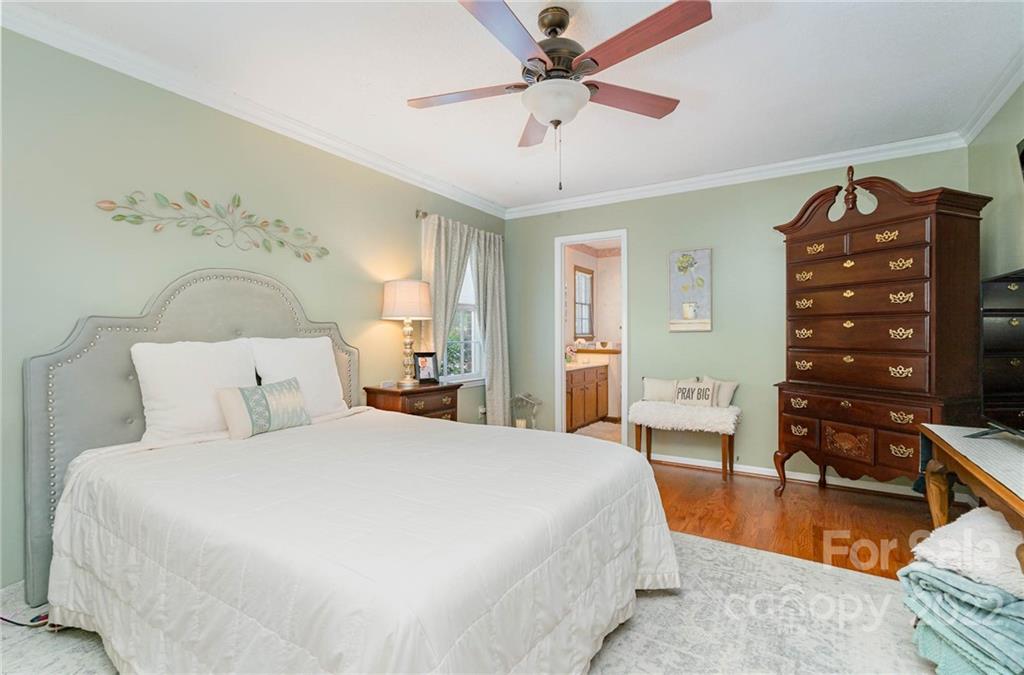 6901 Porterfield Road Charlotte, NC 28226 - Photo 18 of 30 a bedroom with a bed and a chandelier