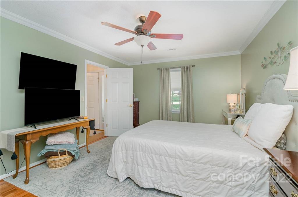 6901 Porterfield Road Charlotte, NC 28226 - Photo 20 of 30 a bedroom with a bed and a flat screen tv