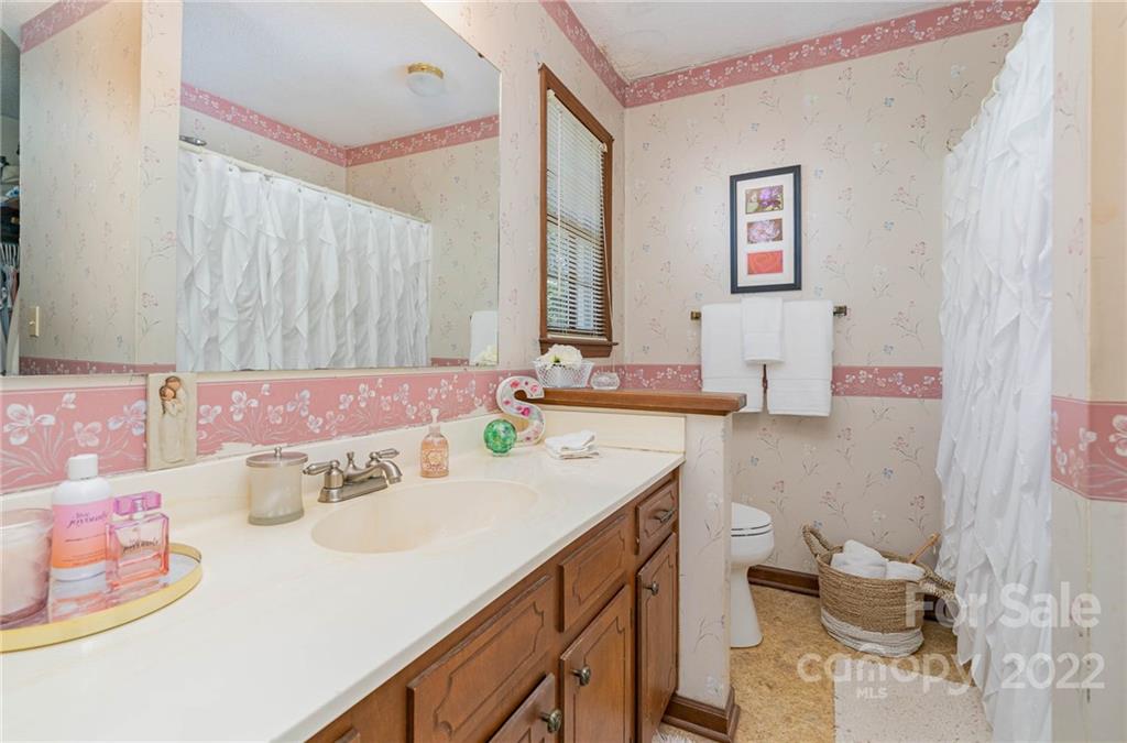 6901 Porterfield Road Charlotte, NC 28226 - Photo 21 of 30 a bathroom with a sink vanity mirror and tub