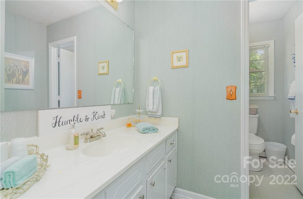 6901 Porterfield Road Charlotte, NC 28226 - Photo 23 of 30 a bathroom with a sink and a mirror