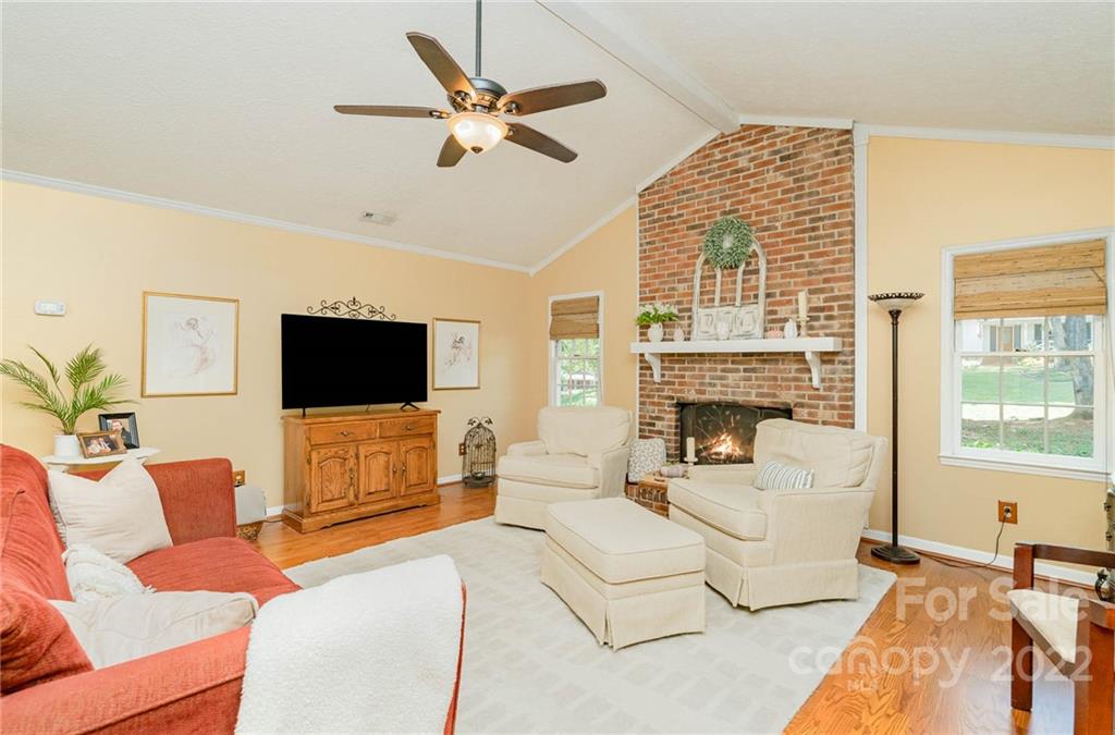6901 Porterfield Road Charlotte, NC 28226 - Photo 8 of 30 a living room with furniture a flat screen tv and a large window