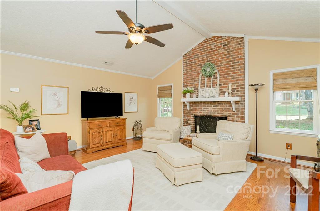 6901 Porterfield Road Charlotte, NC 28226 - Photo 9 of 30 a living room with furniture a flat screen tv and a large window