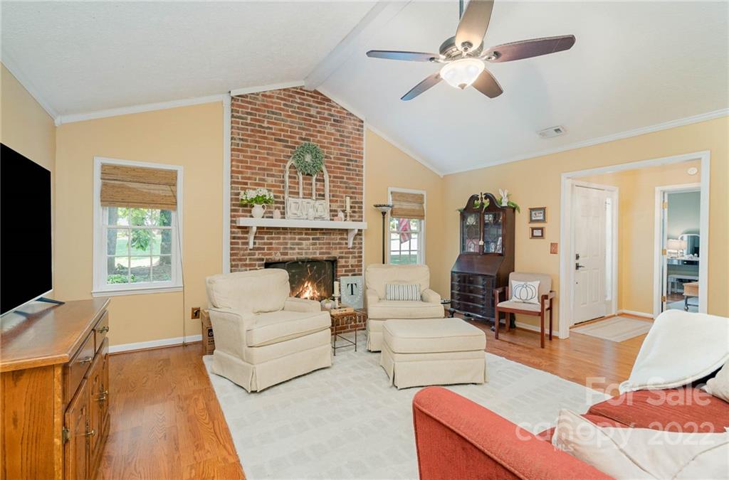 6901 Porterfield Road Charlotte, NC 28226 - Photo 10 of 30 a living room with furniture a fireplace and a flat screen tv