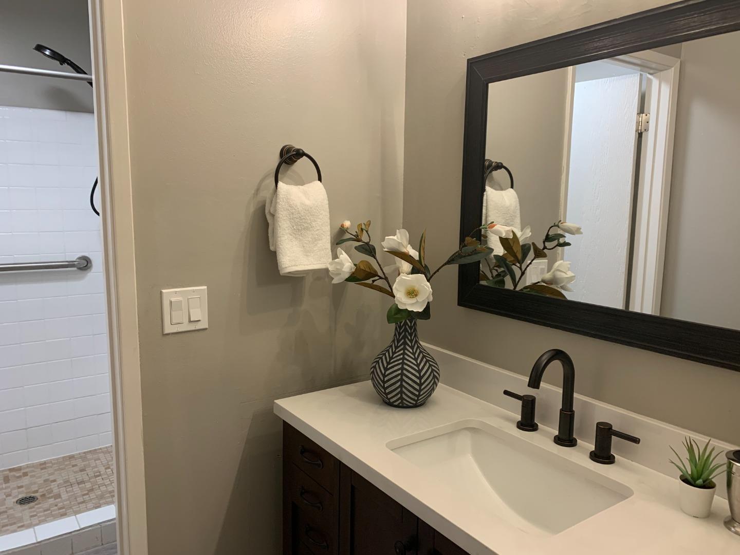 100 East Middlefield Road, Unit 1B Mountain View, CA 94043 - Photo 12 of 18 a bathroom with a sink and a mirror