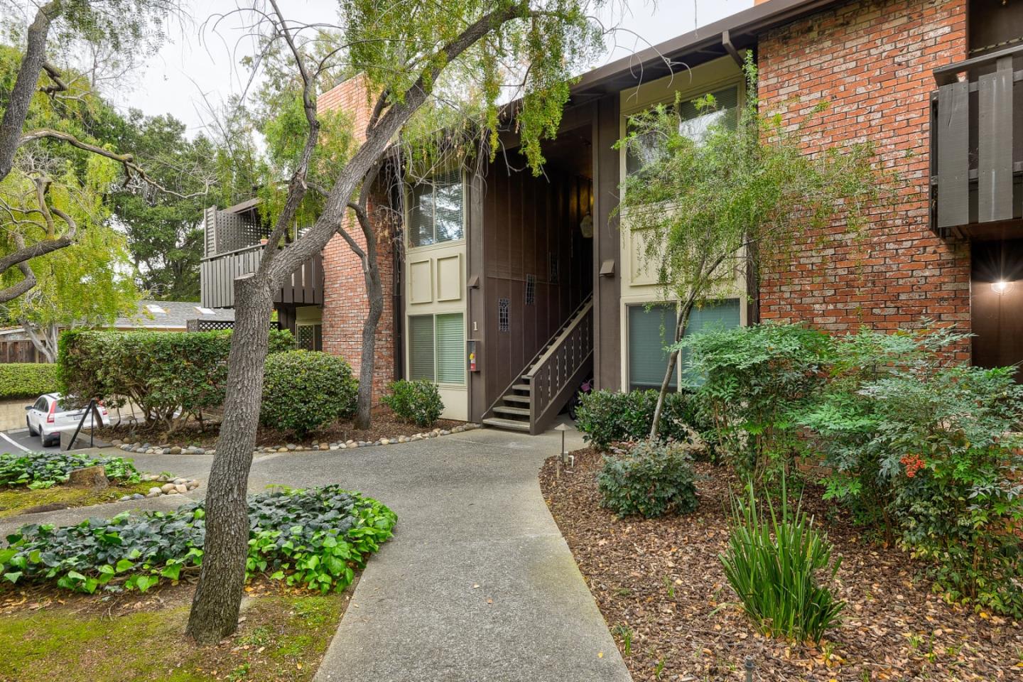 100 East Middlefield Road, Unit 1B Mountain View, CA 94043 - Photo 18 of 18 a front view of a house with a garden