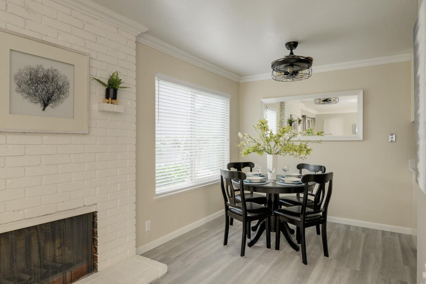 100 East Middlefield Road, Unit 1B Mountain View, CA 94043 - Photo 3 of 18 a view of a dining room with furniture and chandelier