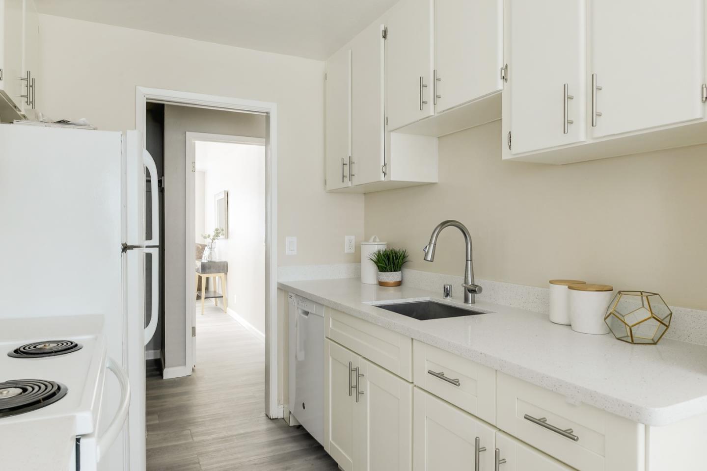 100 East Middlefield Road, Unit 1B Mountain View, CA 94043 - Photo 5 of 18 a kitchen with stainless steel appliances granite countertop a sink and a white stove